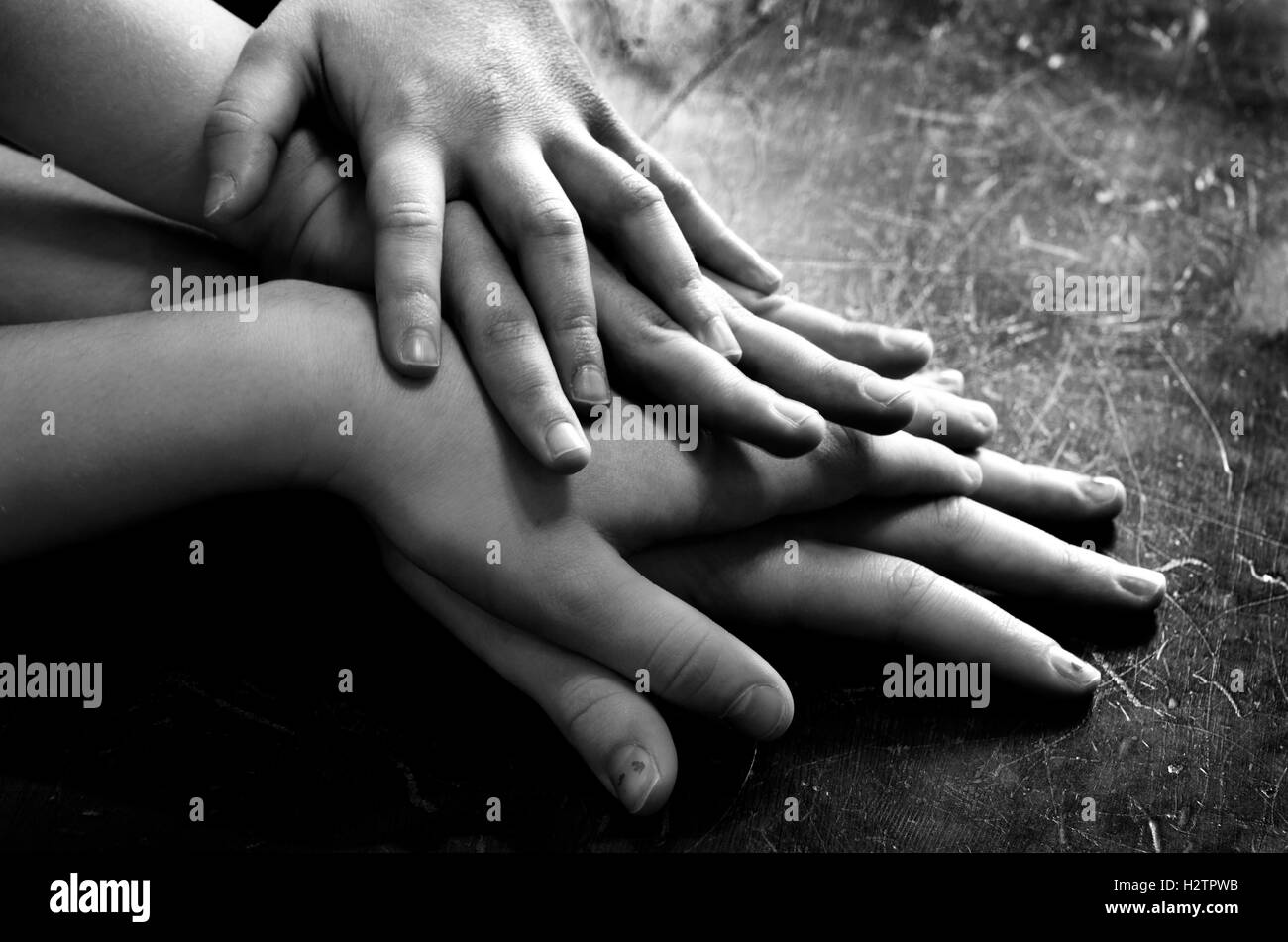 Several children hands on top of each other stacked up love and family group Stock Photo