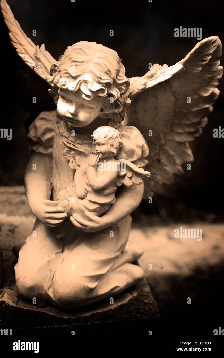 Antique marble statue of a winged angel with stretched out hand Stock Photo