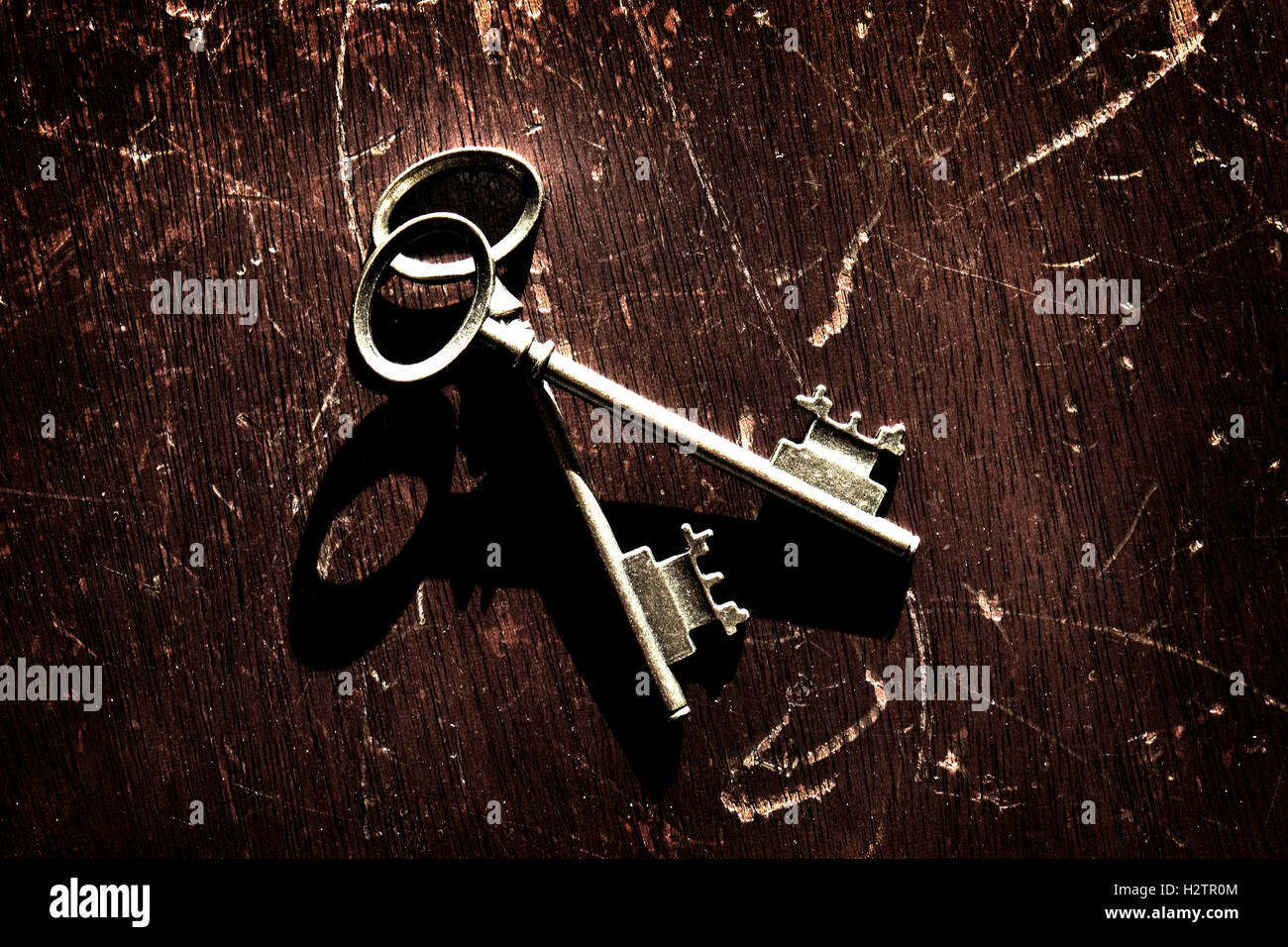 Old keys laying on top of worn wood Stock Photo