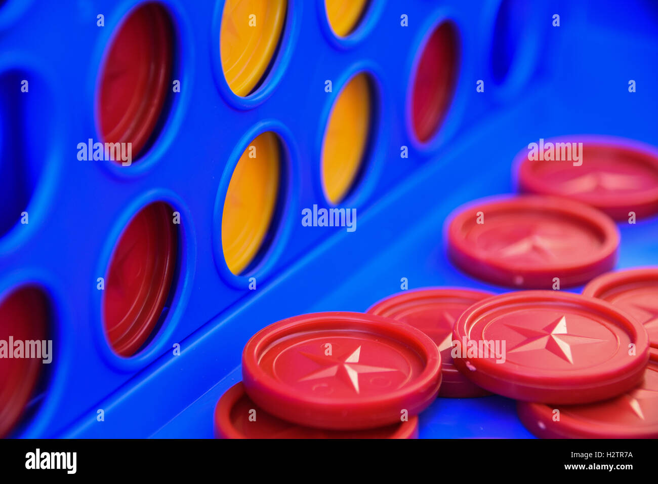 Close up of the red and yellow counters of four in a row game Stock