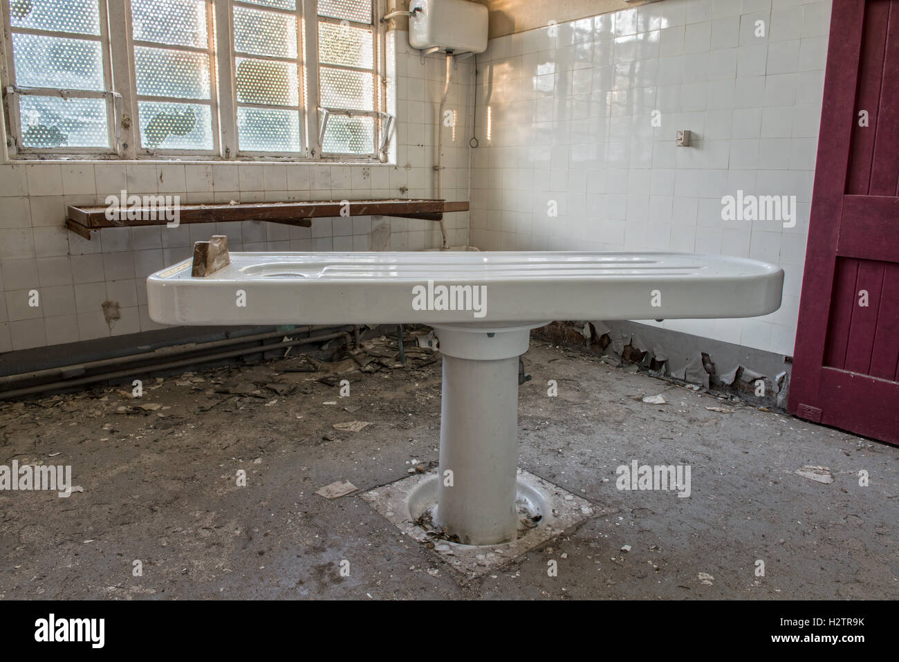 An increasingly rare porcelain autopsy table within the derelict Maiden Law Hospital Mortuary, Lanchester, County Durham, UK Stock Photo