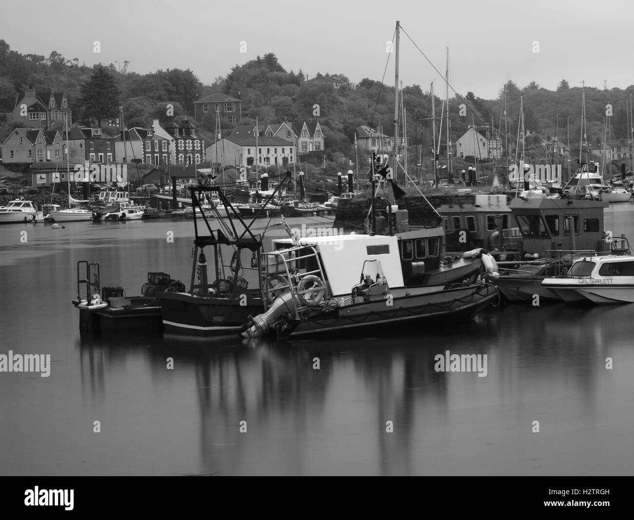 Long exposure of fishing boats in Tarbert Harbour, Scotland. Stock Photo