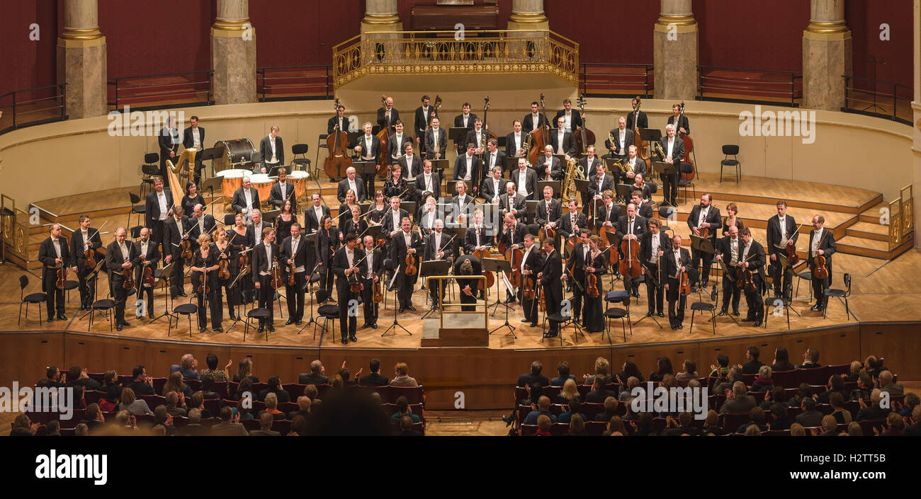 Applause and Bows  The audience applauds while the orchestra players stand and conductor bow  Weiner Symphoniker/Elvind Gullberg Jensen Stock Photo