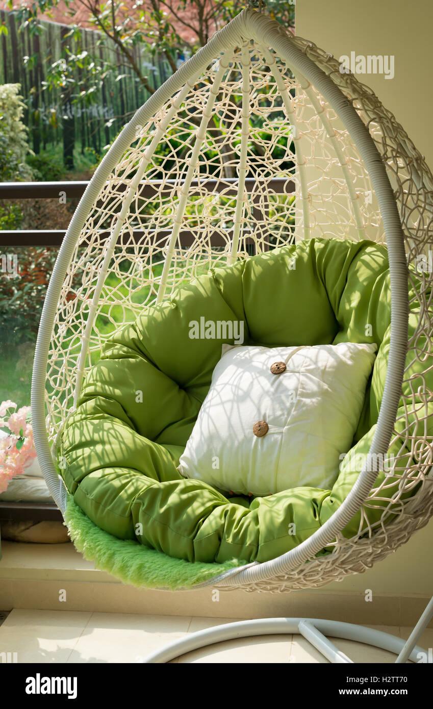 garden swing with mattress and cushion in a balcony in the morning