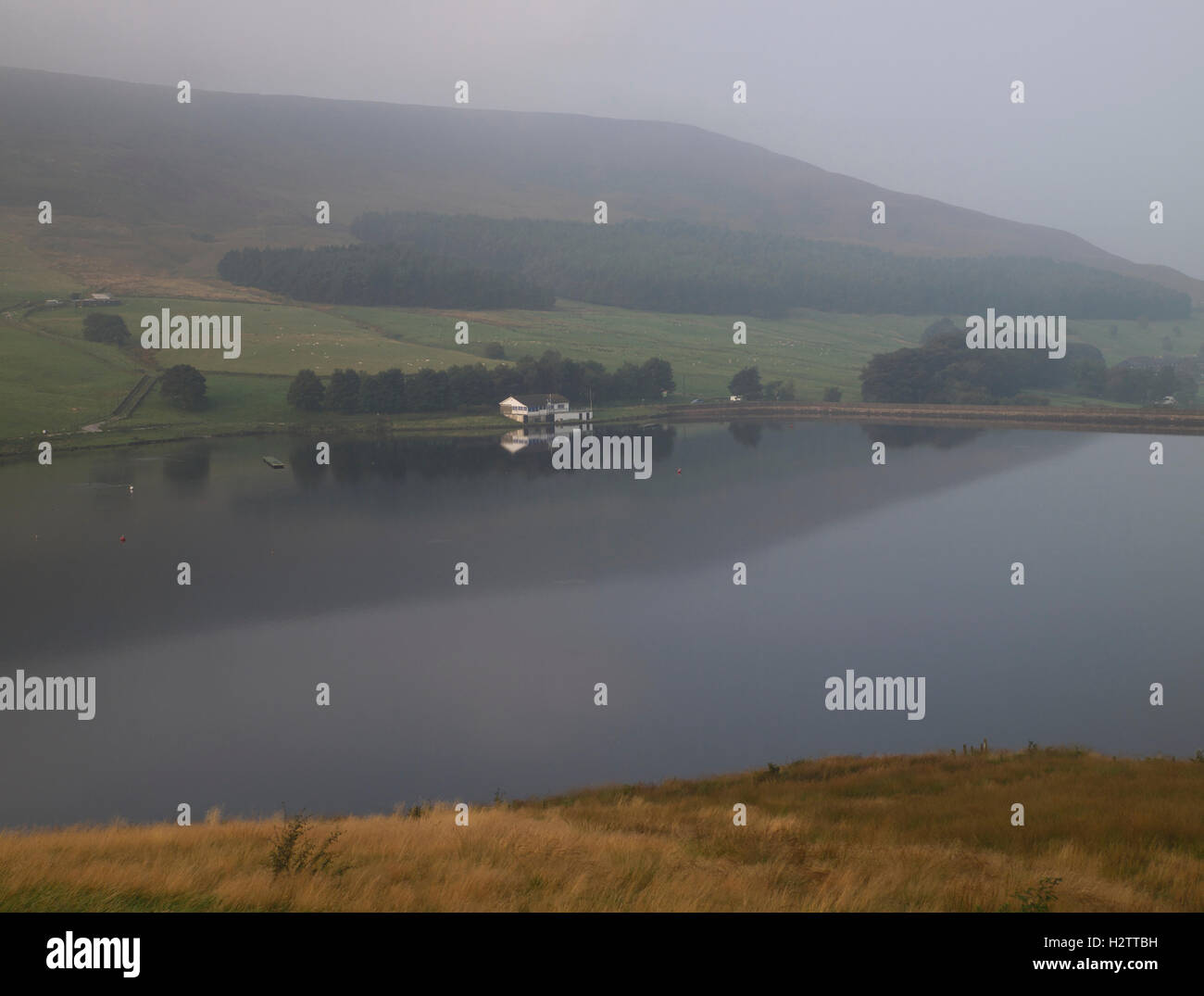 The sailing club in mist from near lonely tree, Dovestone Reservoir, Greenfield Stock Photo