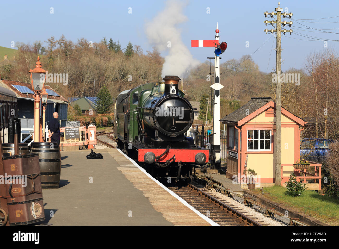 Steam locomotive pulling a passenger train approaching the station, England, UK. Stock Photo