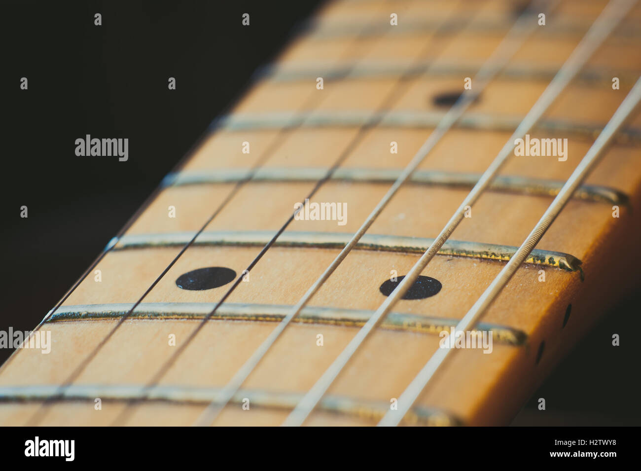 Electric guitar neck detail with light effect, couple of markers point selective focus Stock Photo