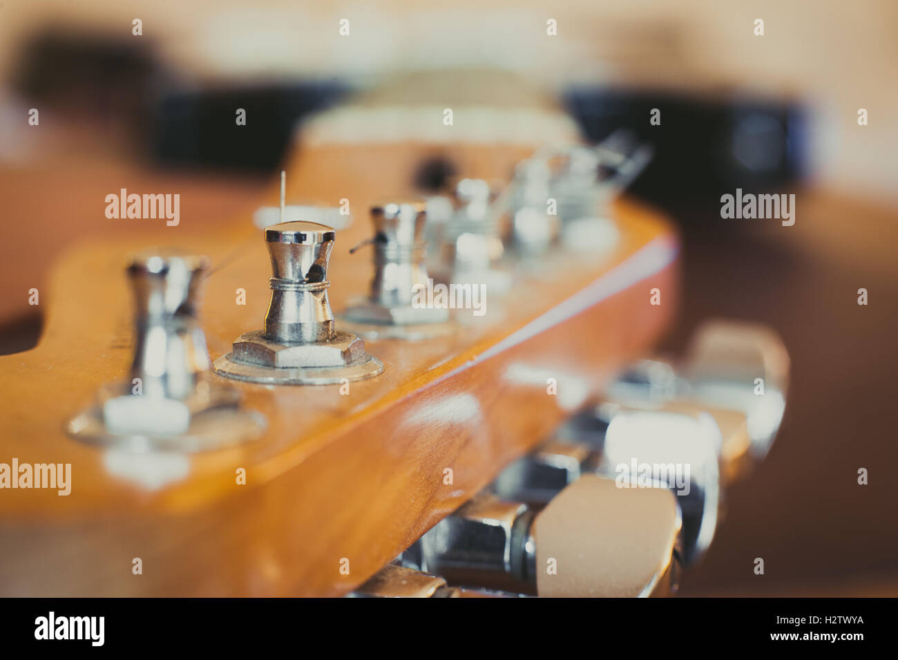 Electric guitar headstock and tuning peg detail with light effect, selective focus Stock Photo