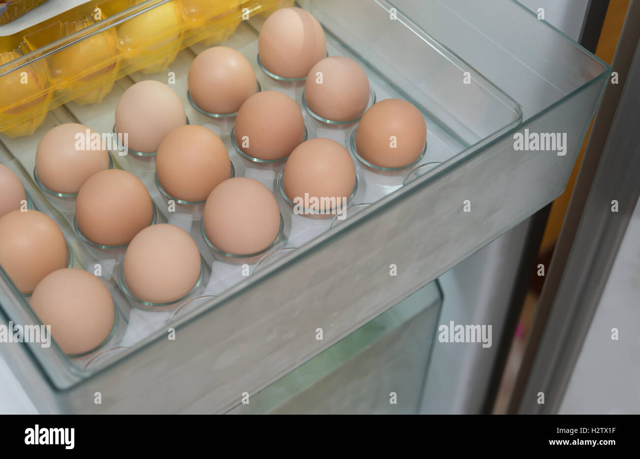 fresh eggs in a shelf of refrigerator Stock Photo