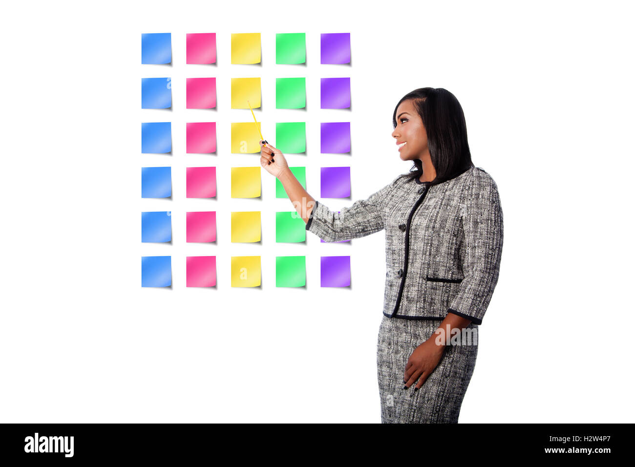 Beautiful happy smiling business woman presenting colorful blank sticky notes, on white. Stock Photo