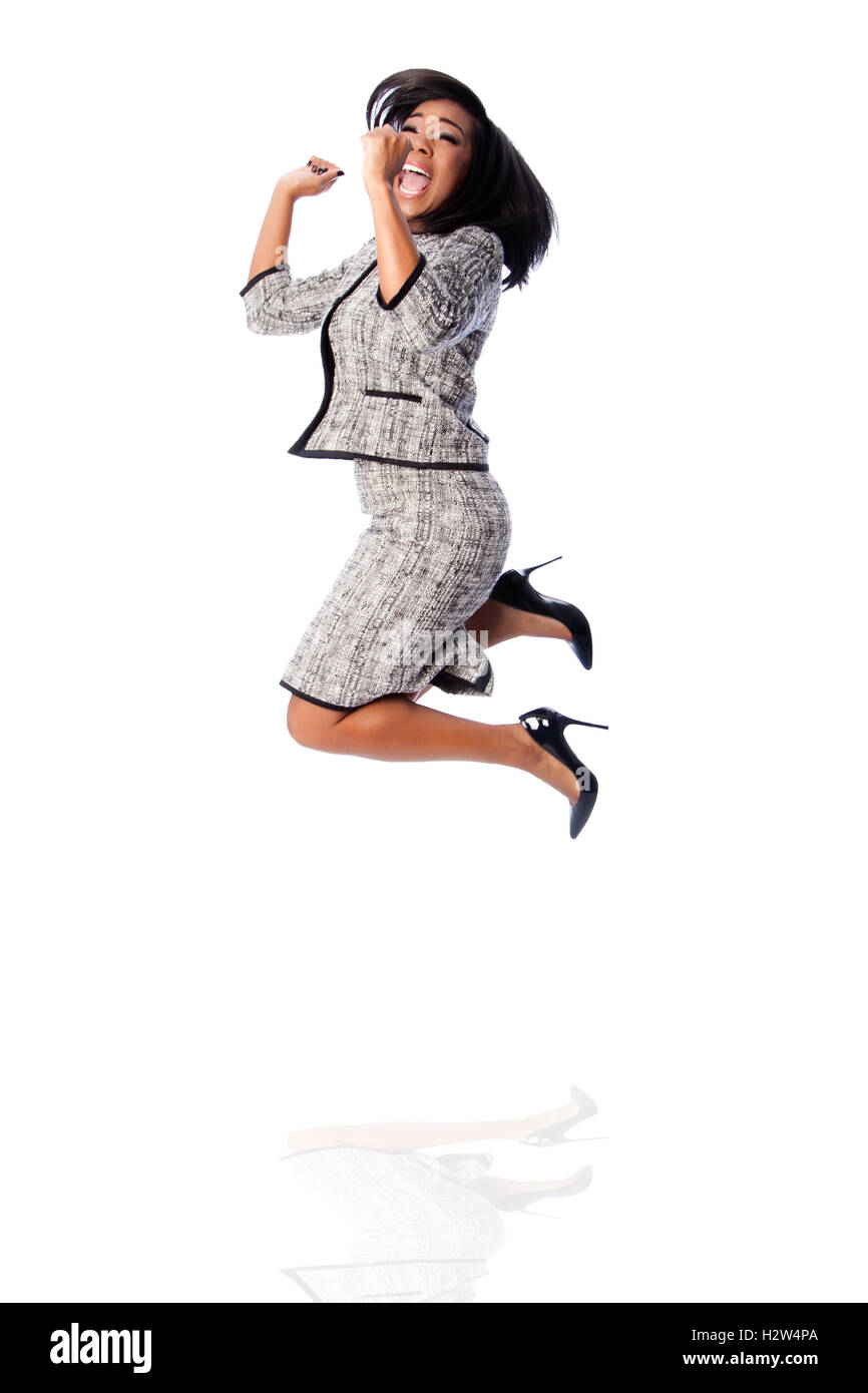 Beautiful happy jumping cheering business woman celebrating joyfully, on white. Stock Photo