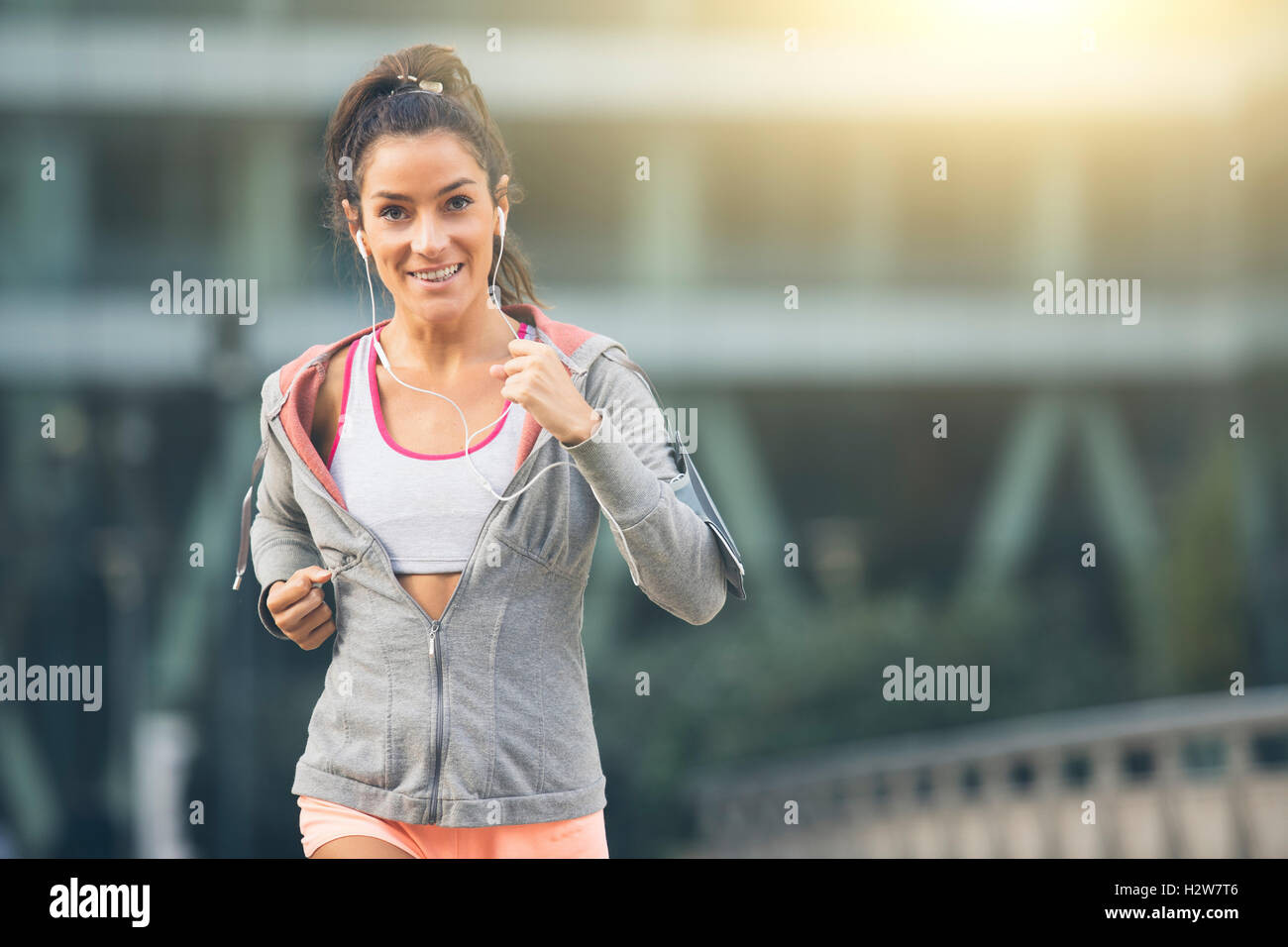 Young woman running in the city street Stock Photo