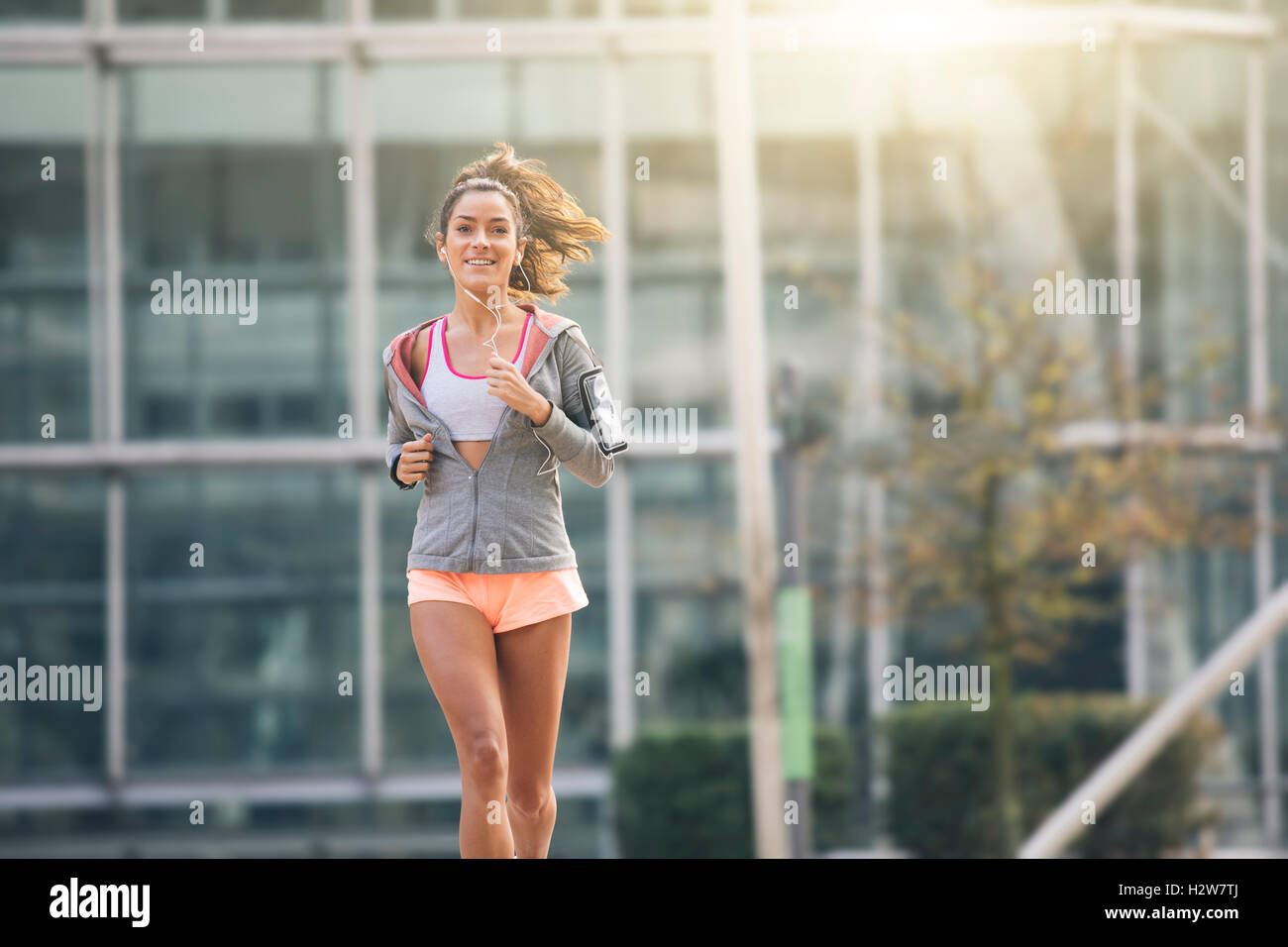 Young woman running in the city street Stock Photo