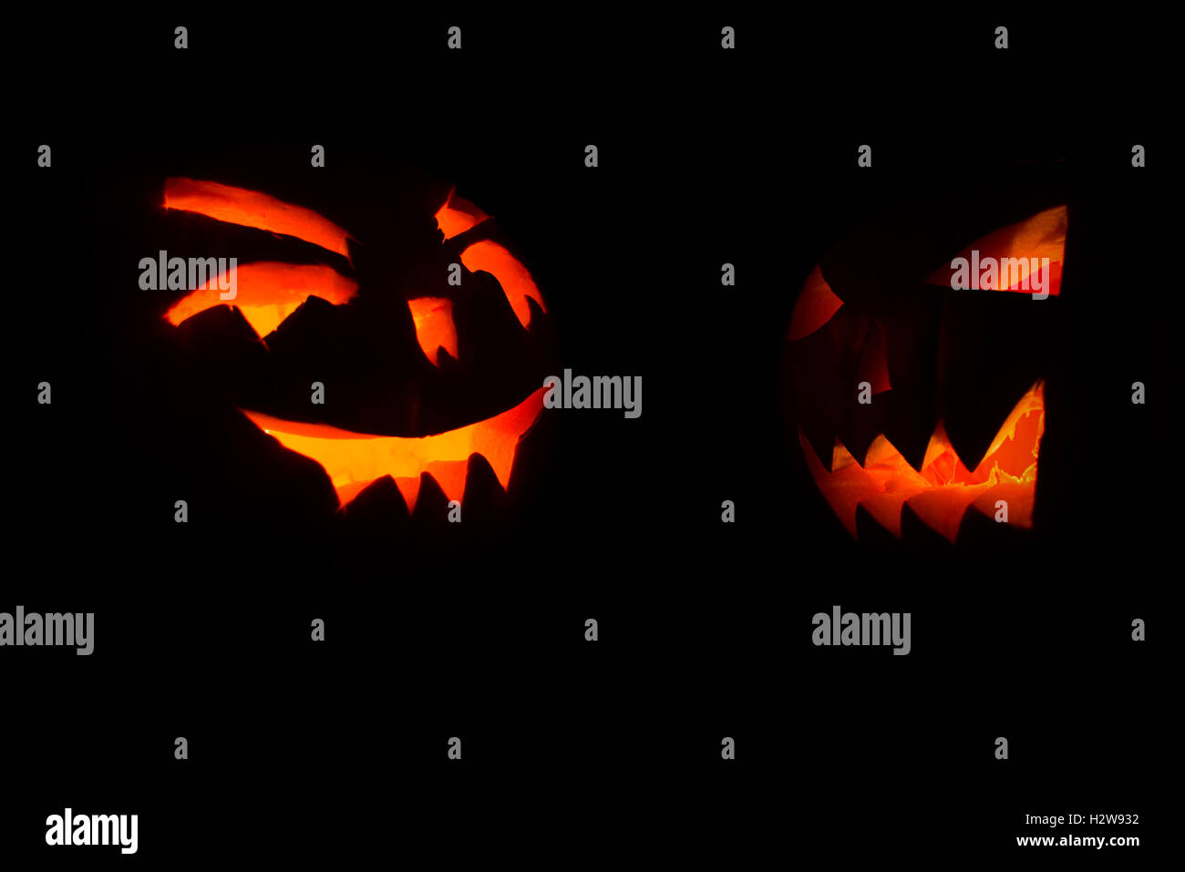 two carved face of pumpkin glowing on Halloween black background Stock ...