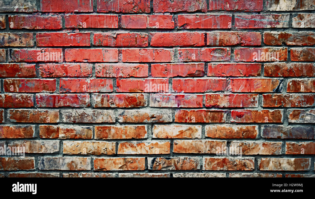 Old brick wall background image. Weathered texture of stained old dark brown and red brick wall