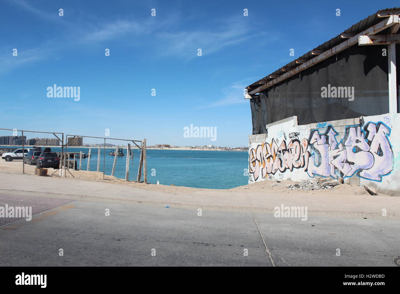 graffiti on a building outlooking an ocean Stock Photo