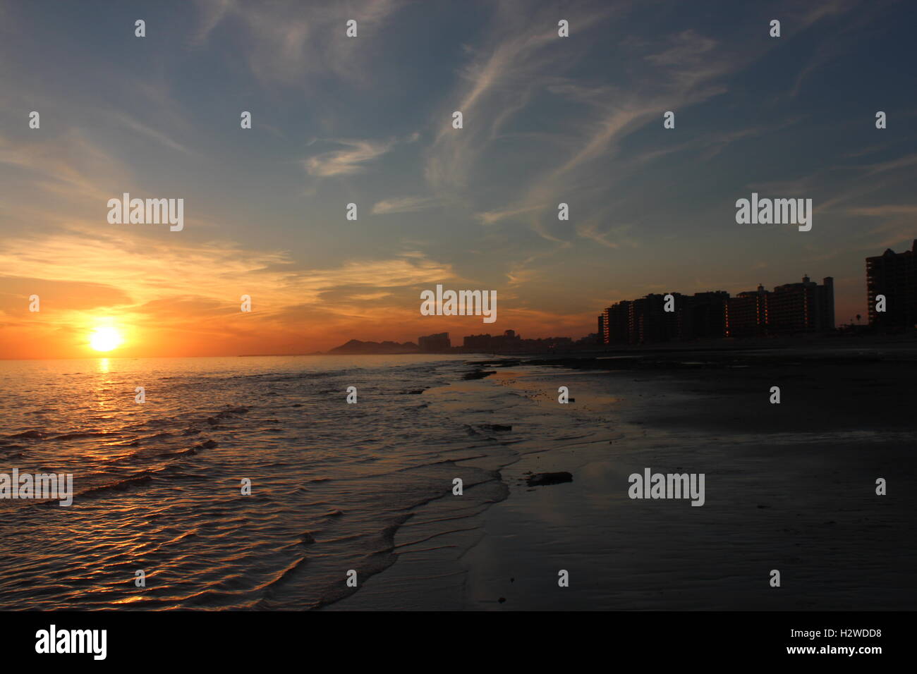 a sunset on a beach Stock Photo - Alamy