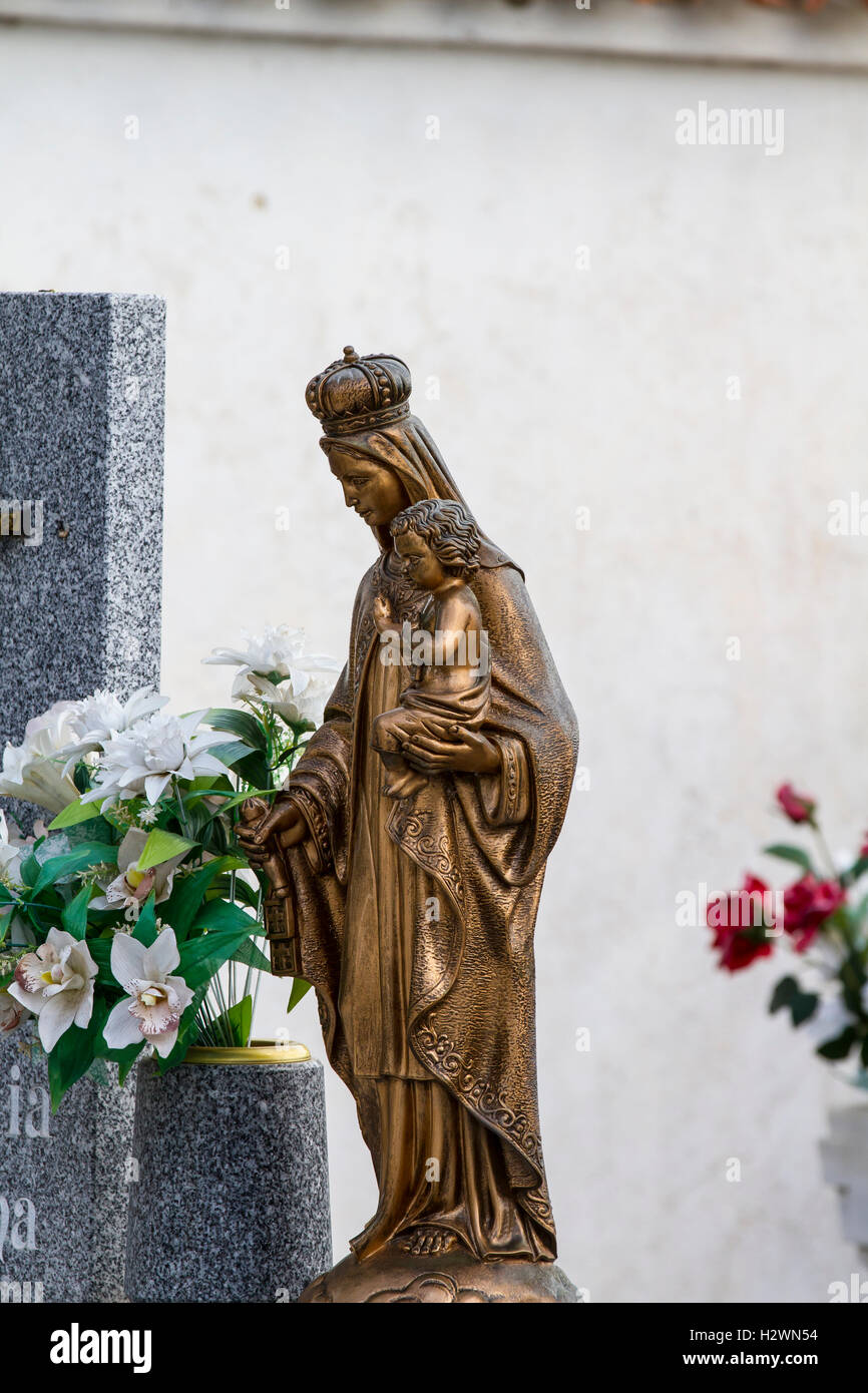 sculpture of the Virgin Mary in a cemetery Stock Photo Alamy