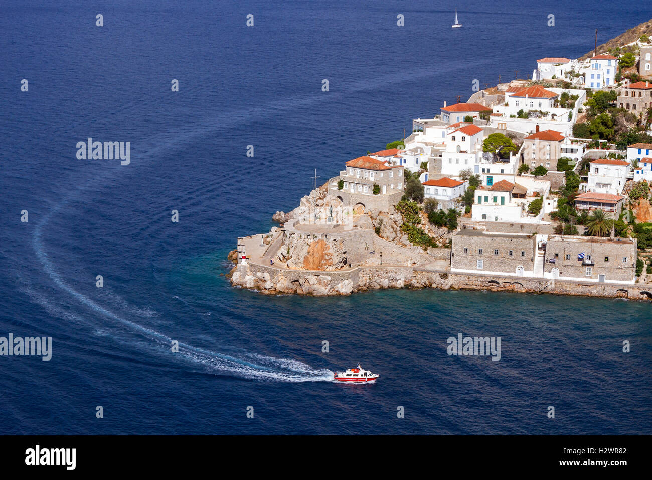 A sea taxi is just entering the port of Hydra island, in Argosaronic Gulf, near Athens, Greece. Stock Photo