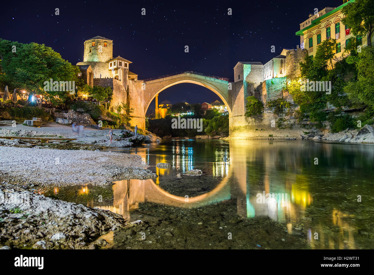 A view of the Mostar skyline at night towards the Old Bridge (Stari Most). Buildings and the River Neretva can be seen. Stock Photo