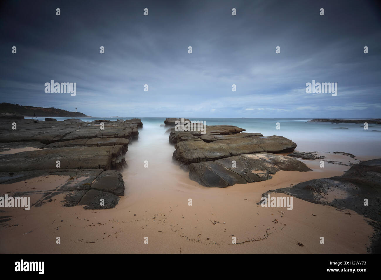 Stormy beach with natural rock channel Soldiers Beach point Stock Photo