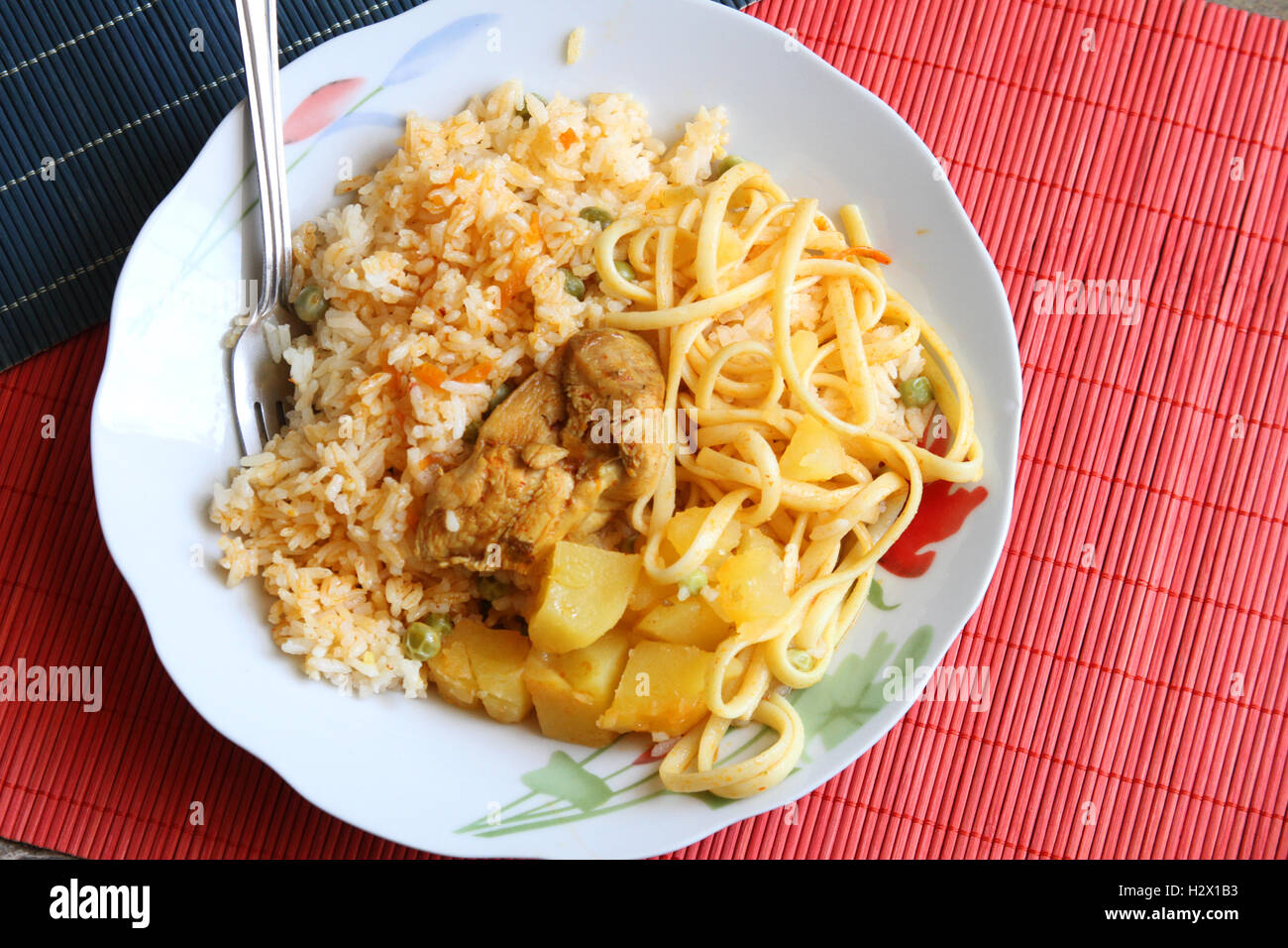 Bowl of cooked chicken with rice, potatoes and noodles in Peru Stock