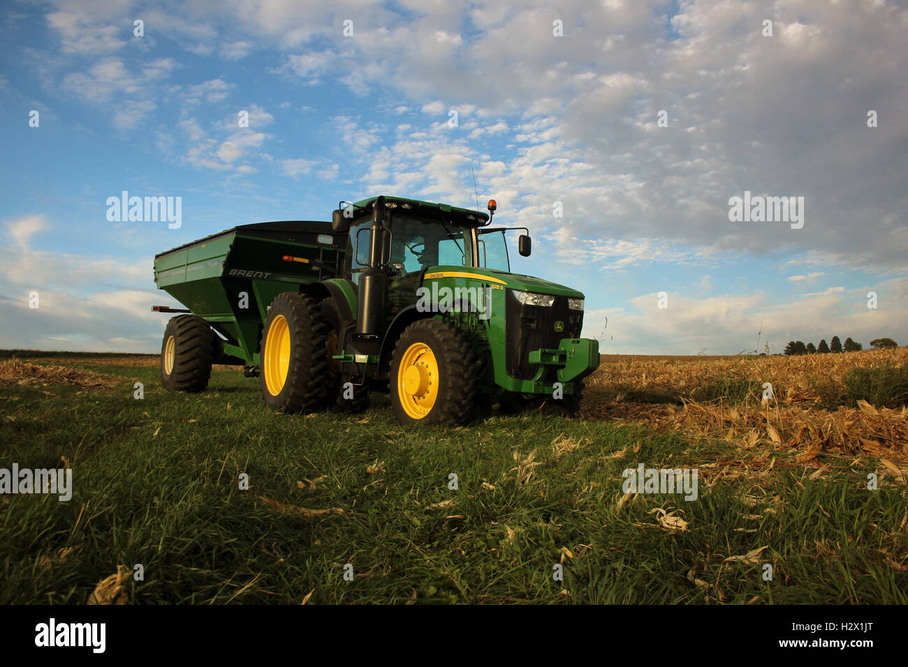 John Deere tractor with grain cart parked on a hill in Iowa Stock Photo