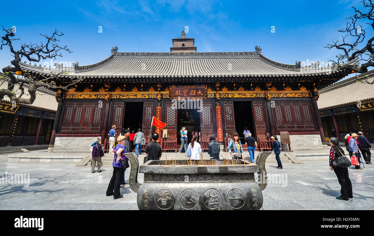 Xian, China - Apr. 7, 2012: Tourists visit the Hall of Sakyamuni, a Buddhist Shrine in Xian China. Stock Photo