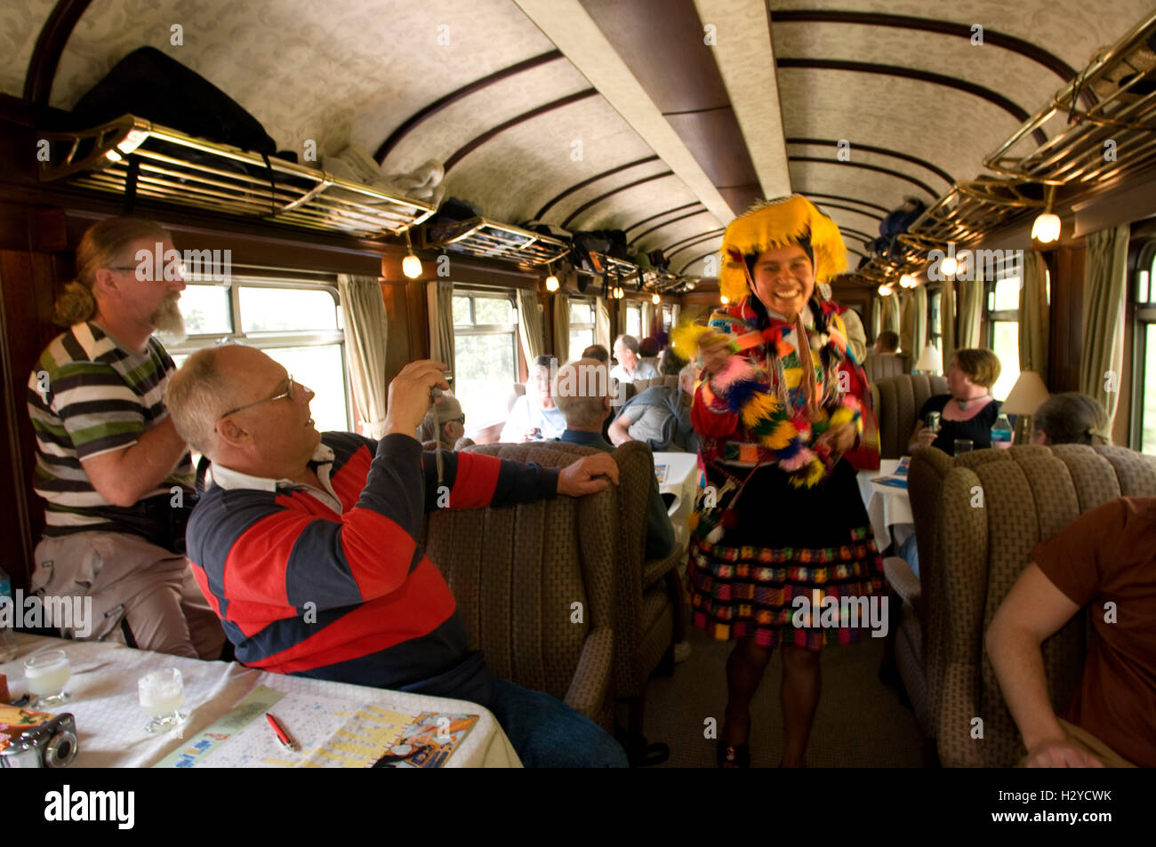 Andean Explorer, luxury train from Cusco to Puno. Train inside. Musicians and dancers in traditional costumes ride on beautify t Stock Photo