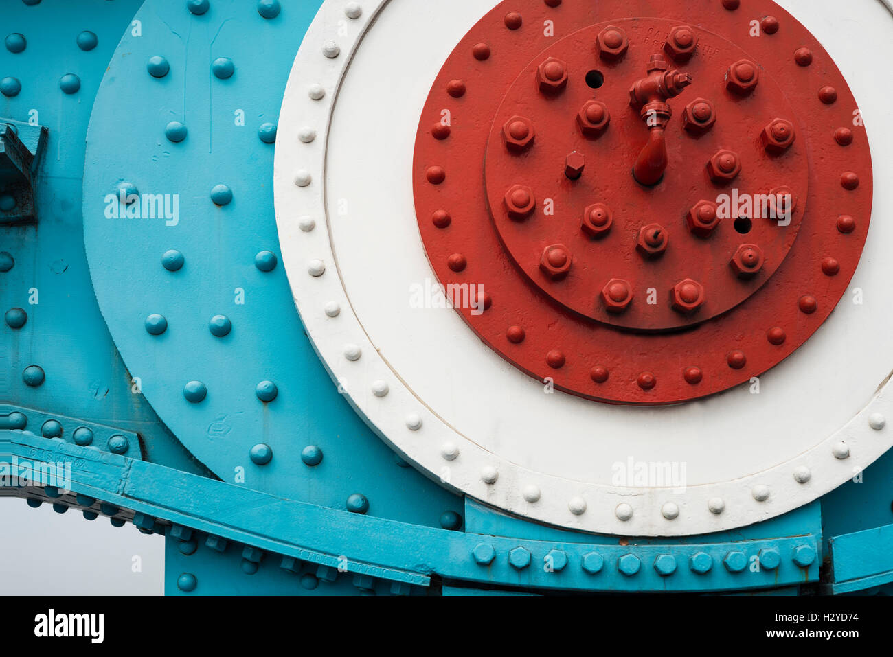 Colorfully painted steel parts with nuts, bolts and rivets of two chain link elements of the Tower Bridge suspension bridge in London, UK Stock Photo