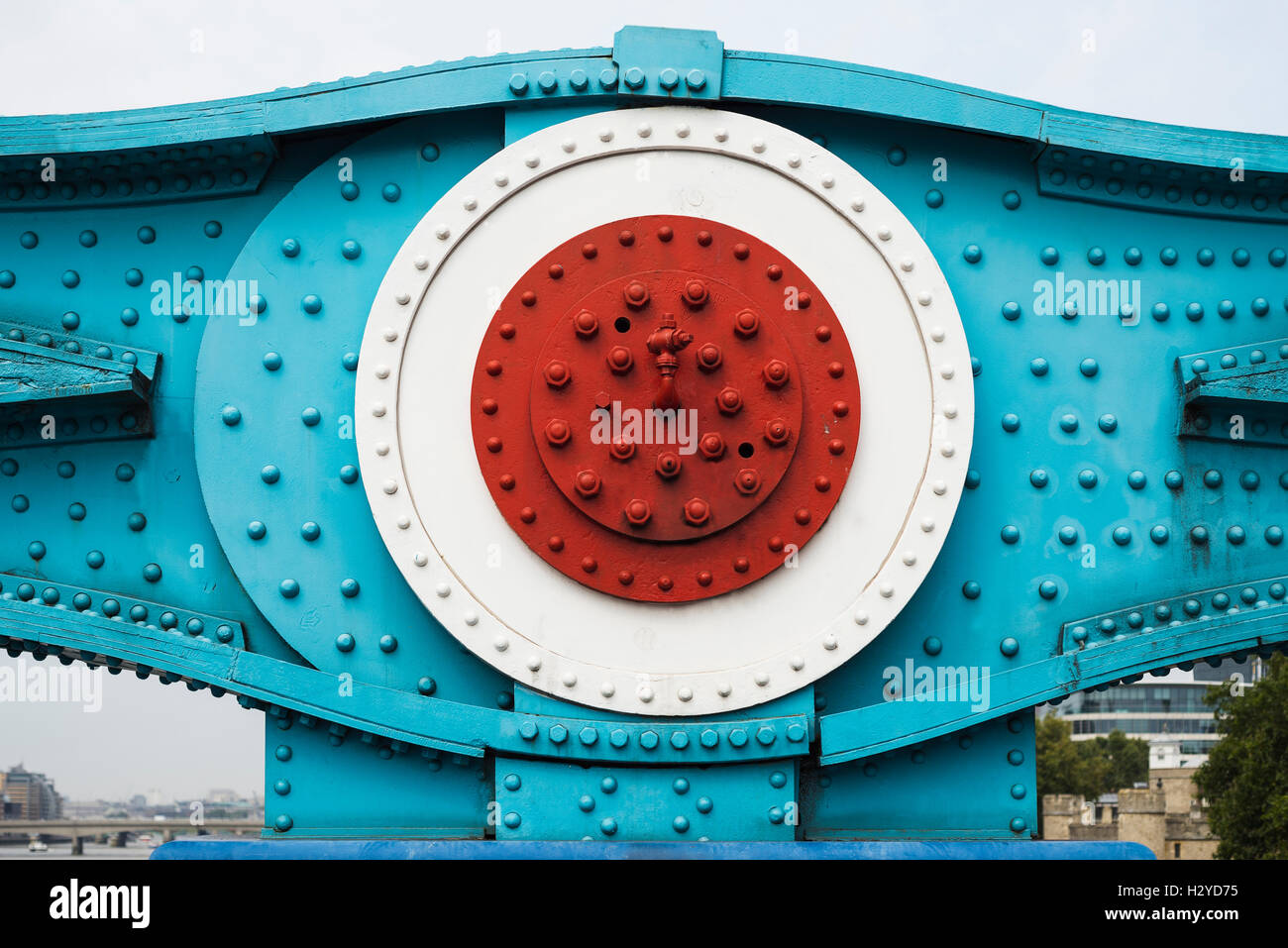 Colorfully painted steel parts with nuts, bolts and rivets of two chain link elements of the Tower Bridge suspension bridge in London, UK Stock Photo