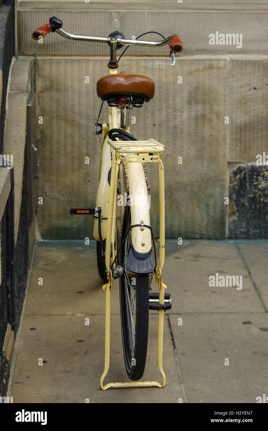 A old yellow bicycle. leather seat with shock absorbers and wheel Stock Photo