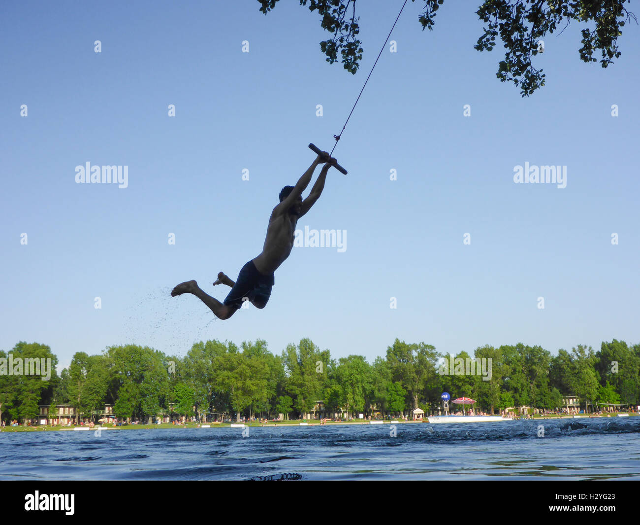 Wien, Vienna: young man at swing over water, Alte Donau (Old Danube), 22., Wien, Austria Stock Photo