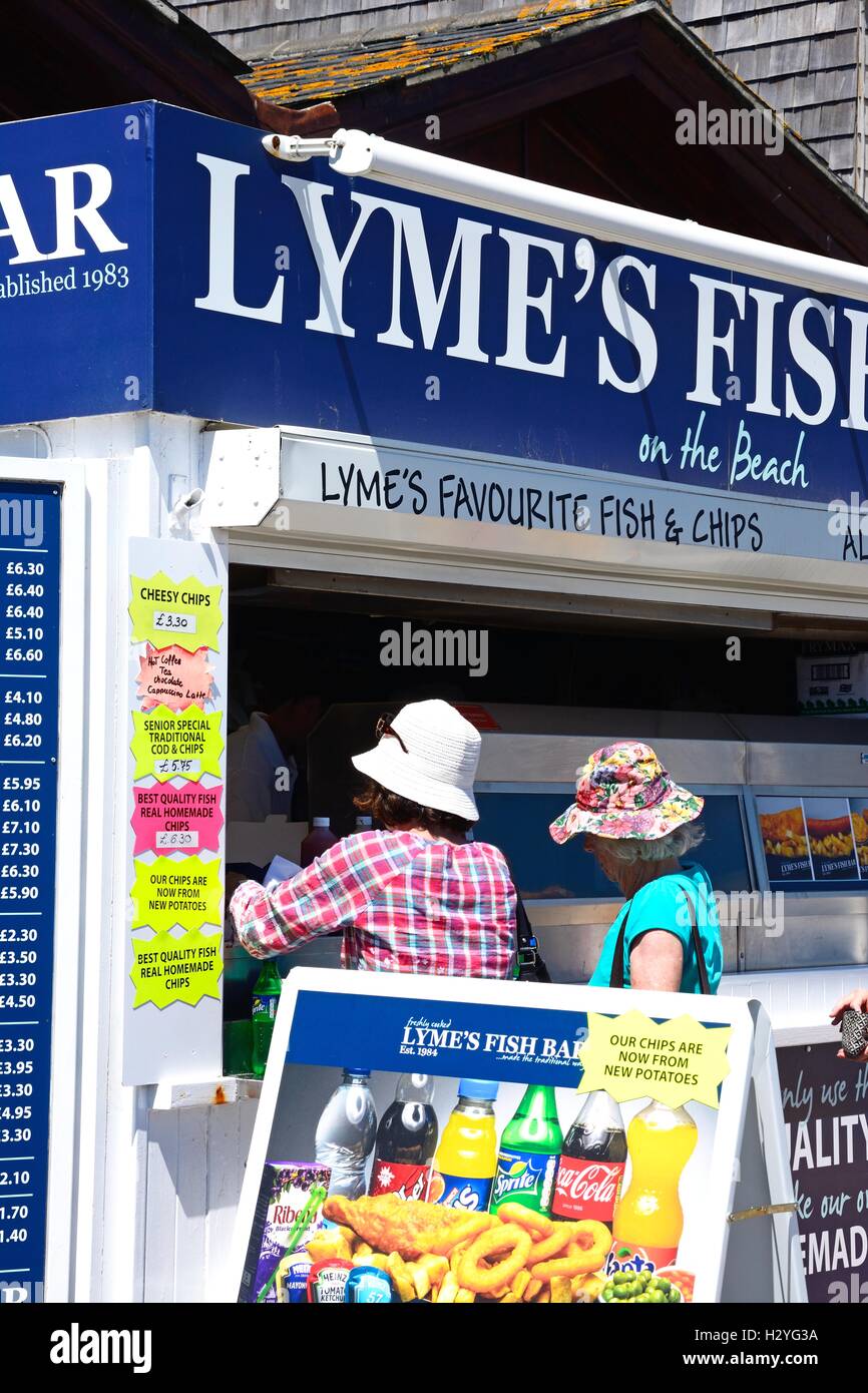 Tourists queuing to buy fish and chips from a beach front chip shop