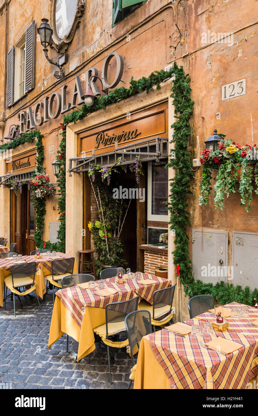 Outdoor tables and facade of er Faciolaro restaurant pizzeria, Rome, Italy Stock Photo