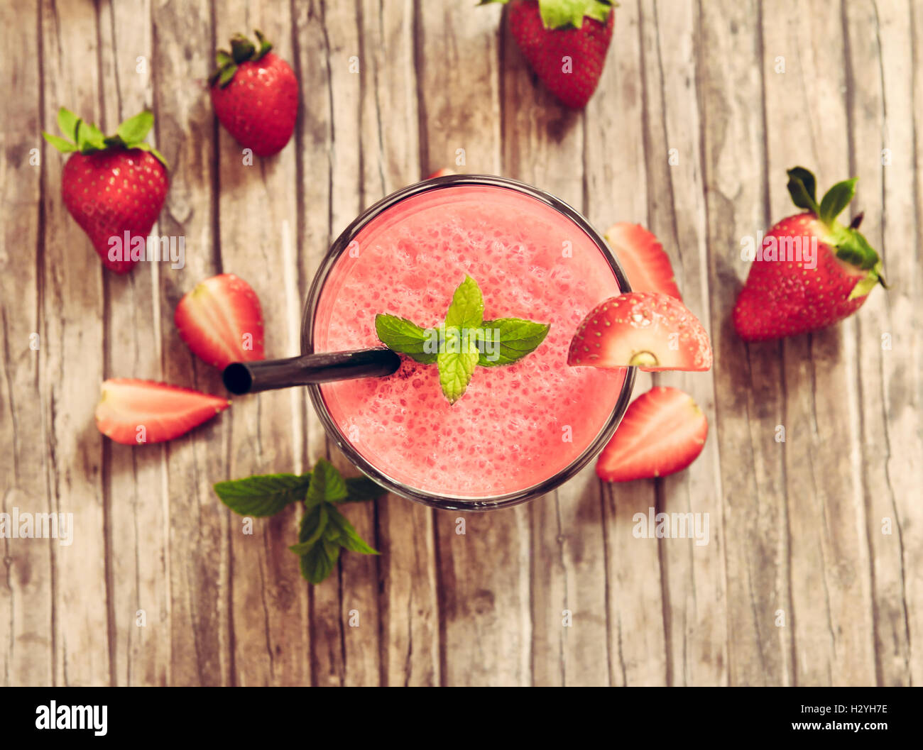 strawberry smoothie in glass on wooden rustic table Stock Photo