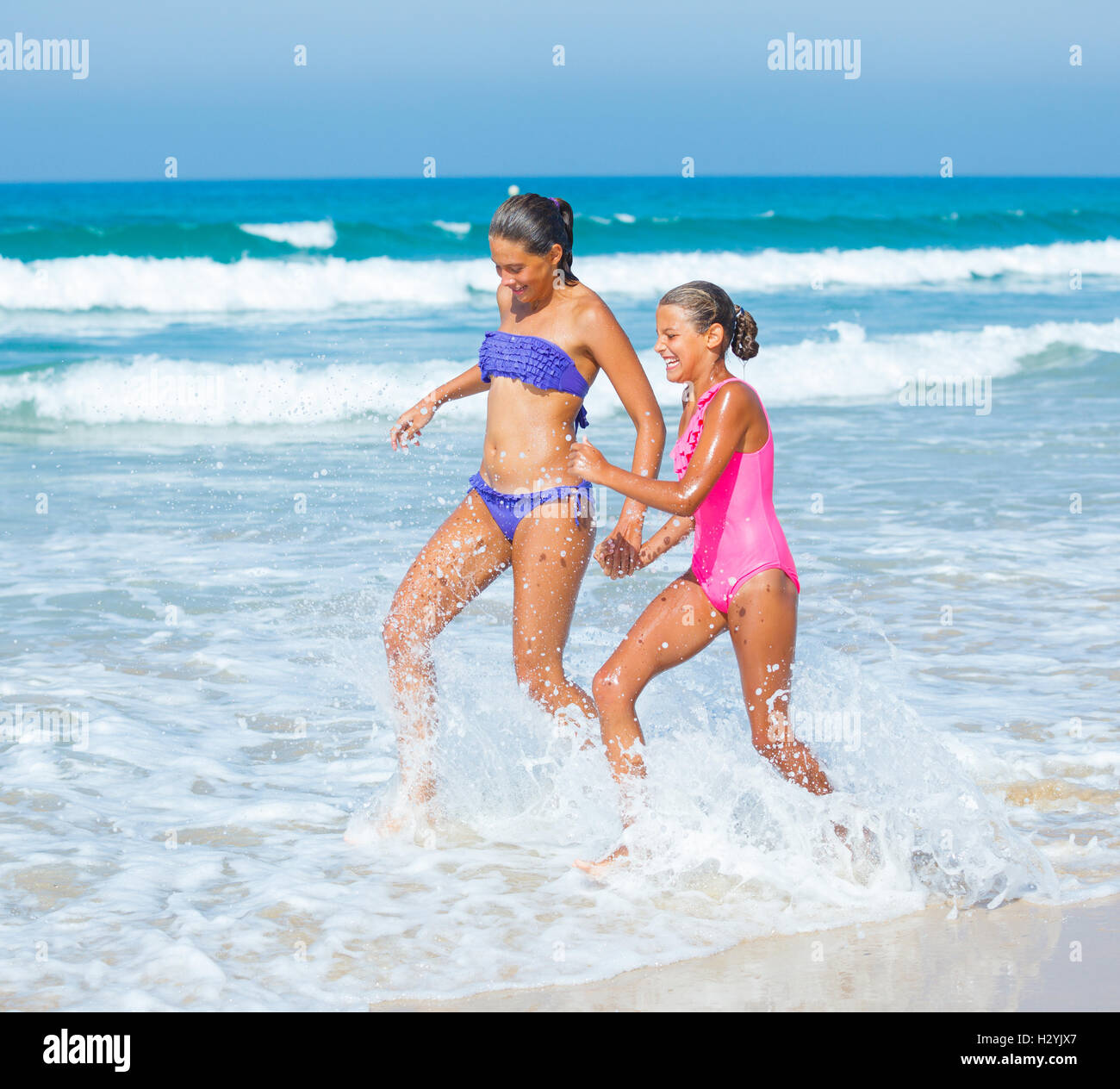 Girls running beach Stock Photo
