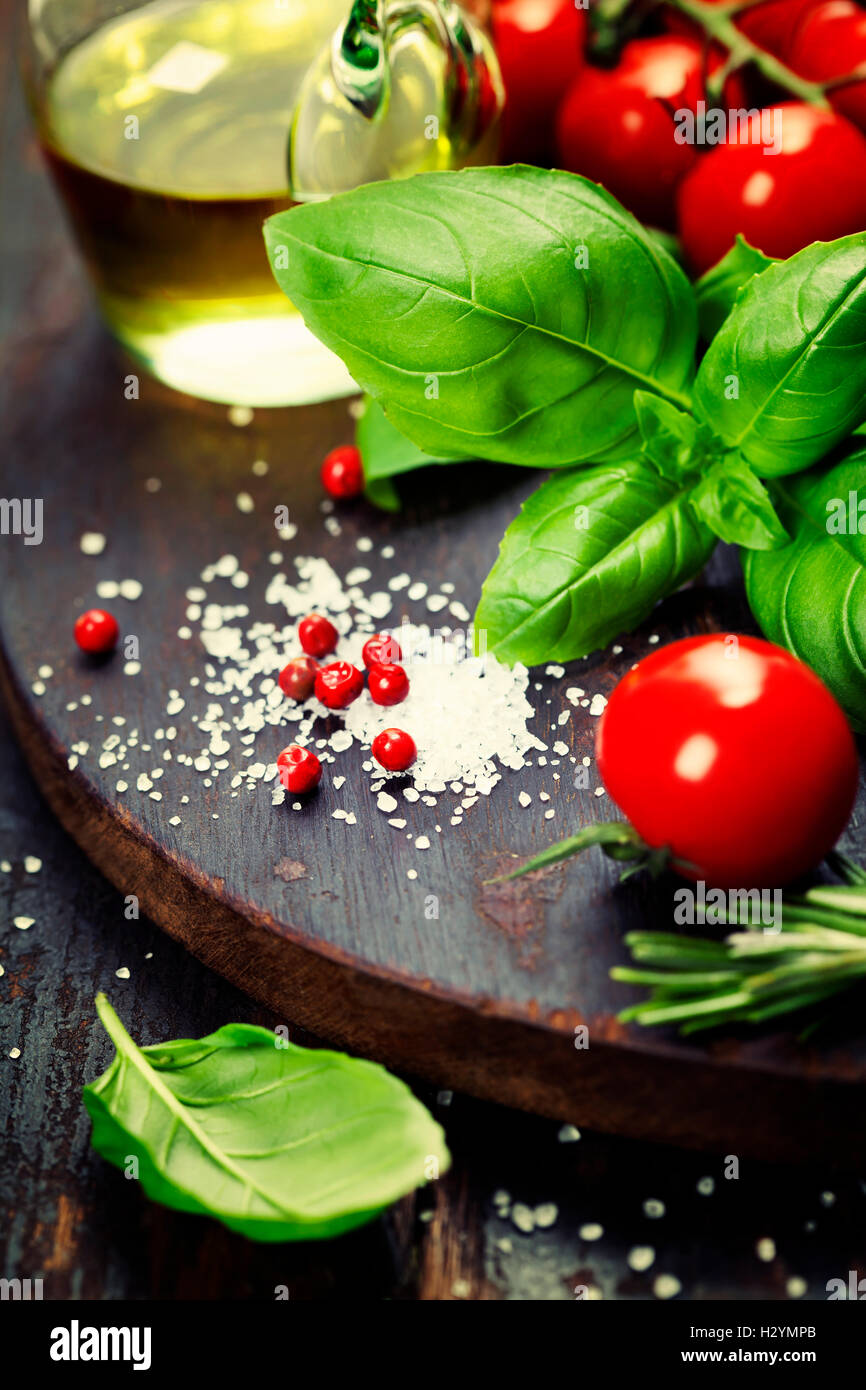 Tomatoes with basil on wooden table background Stock Photo - Alamy