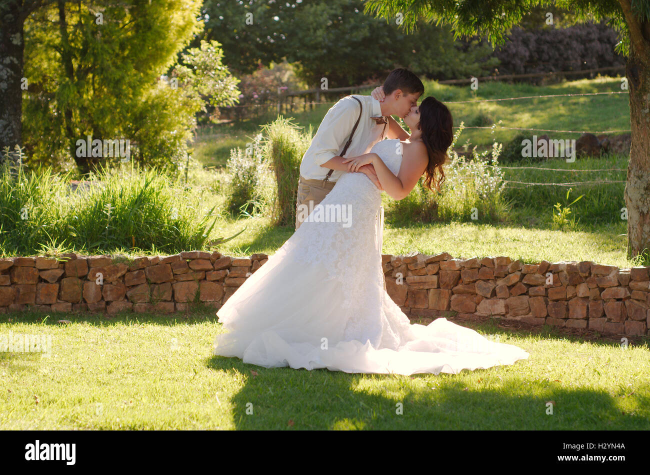 Bride and groom kissing in garden wedding Stock Photo - Alamy