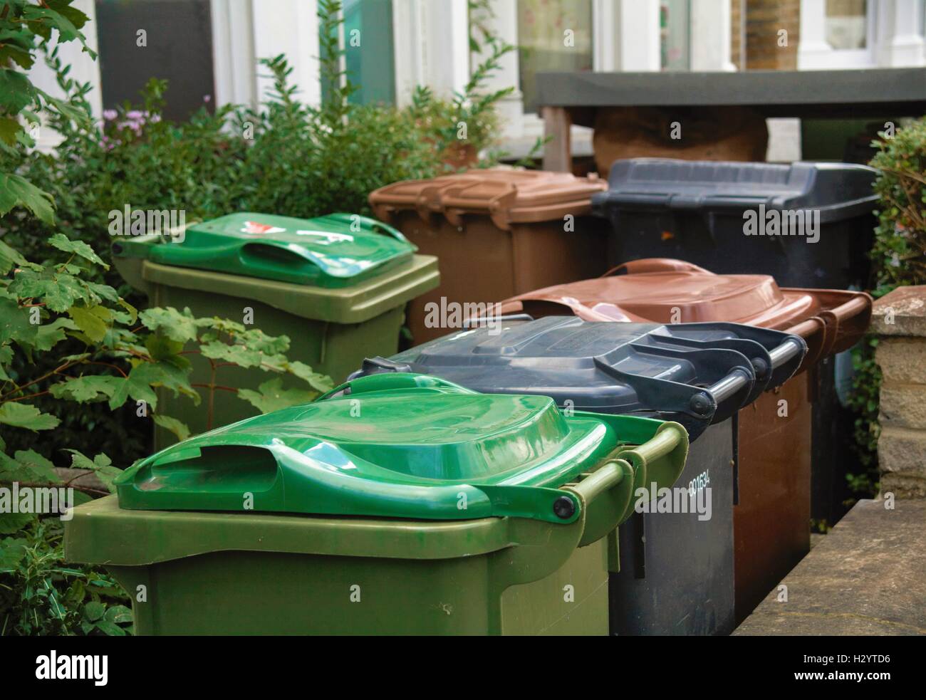 Plastic wheelie bins for general waste, recycling and garden waste in front of house in Waltham Forest , London England Stock Photo