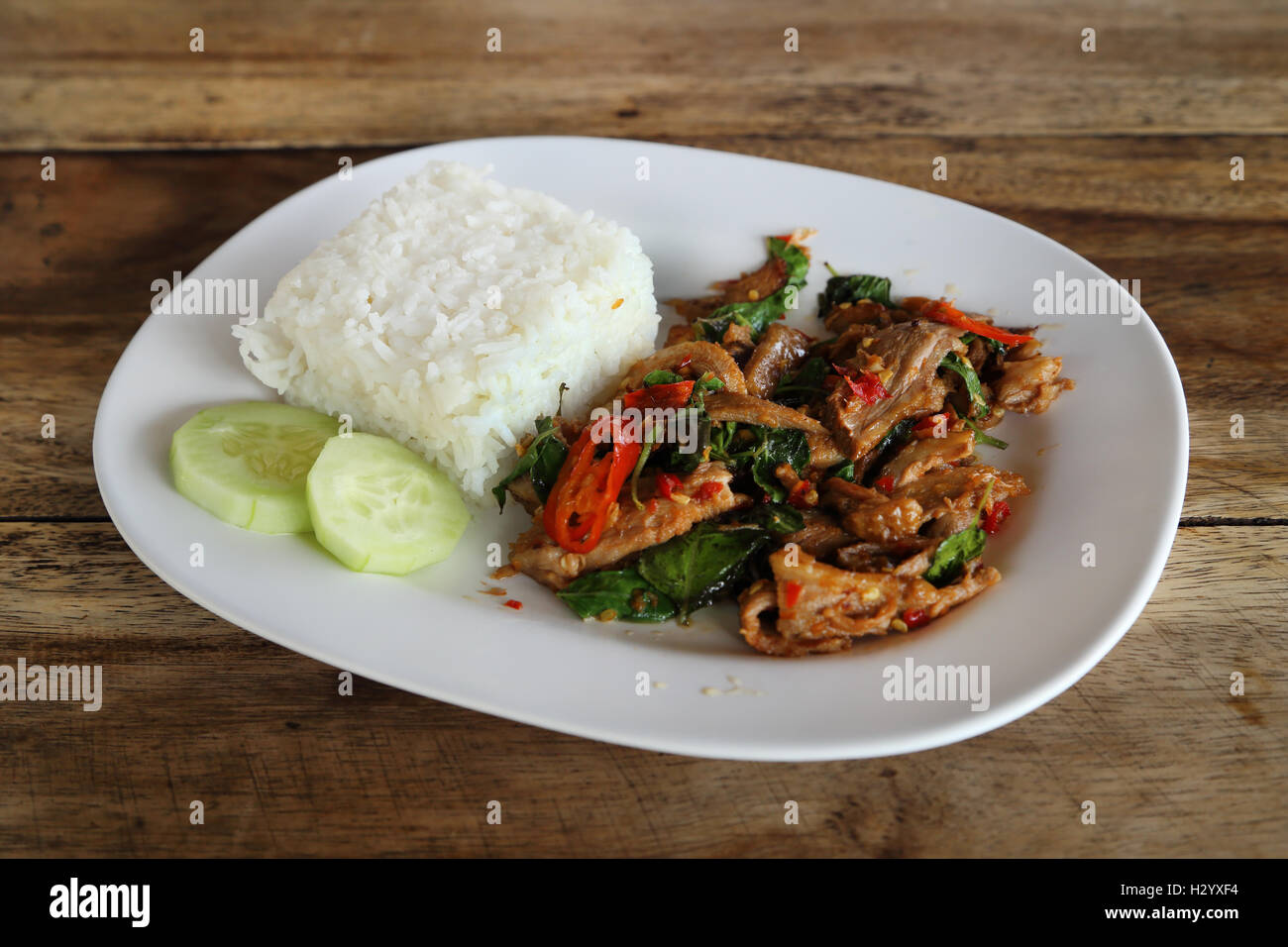 Fried pork with sweet basi and white jasmine sticky rice Stock Photo