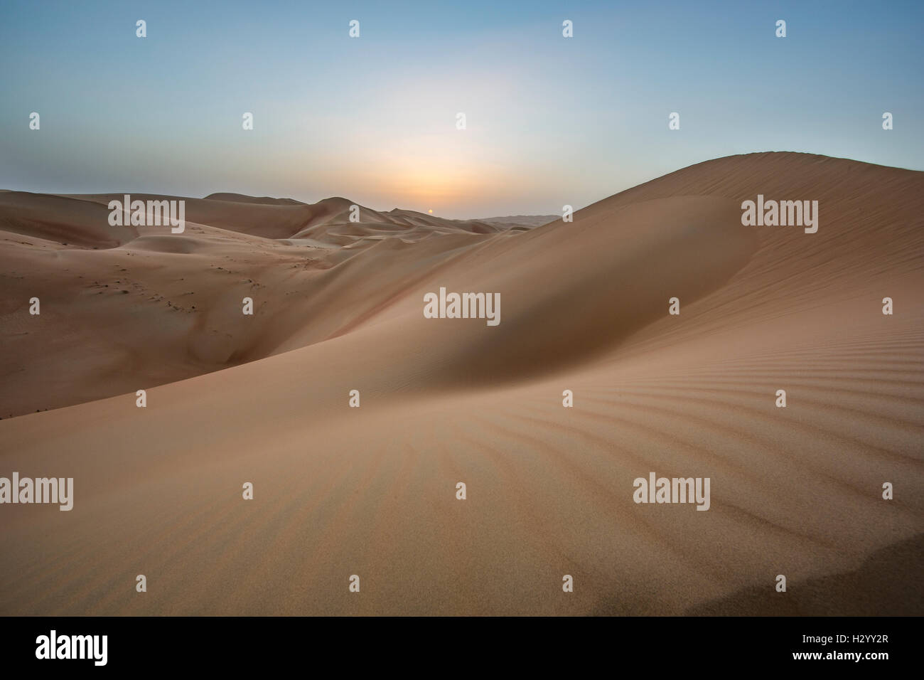 Sunset over massive sand dunes of the Empty Quarter desert, covering large area in UAE, KSA and Oman Stock Photo