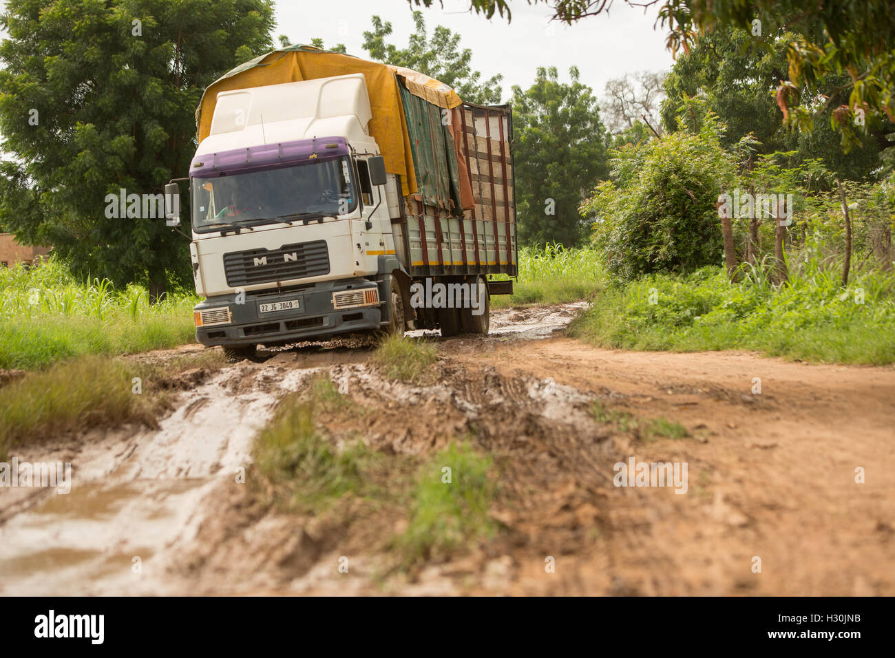 A lorry navigates poor rural road conditions in Réo, Burkina Faso, West Africa. Stock Photo