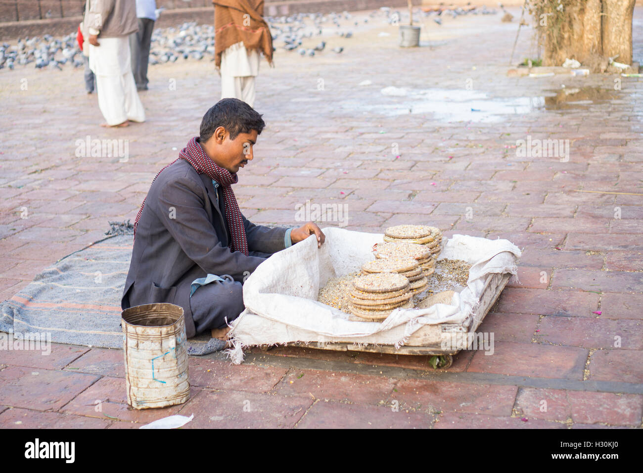 Paksitani man selling food on the street outside Shah Rukn e Alam Shrine Multan Pakistan Stock Photo