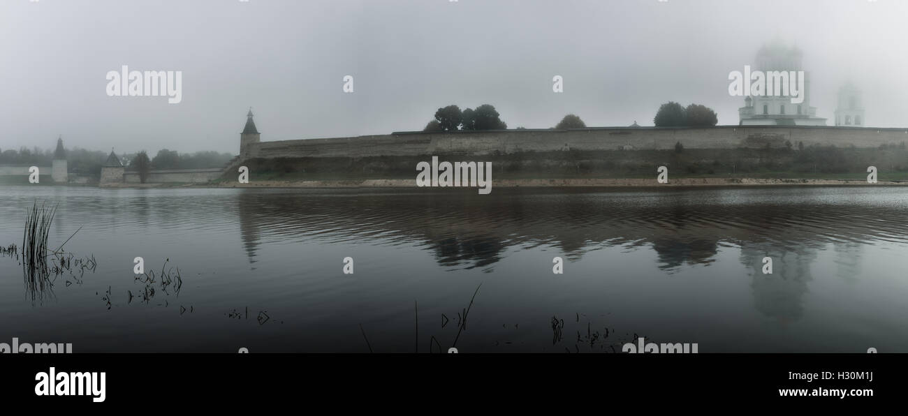 panorama of the river and Pskov Kremlin in the fog on a grey background Stock Photo