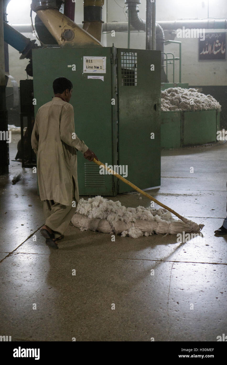 Cotton mill working swiping the floor Multan Pakistan Stock Photo