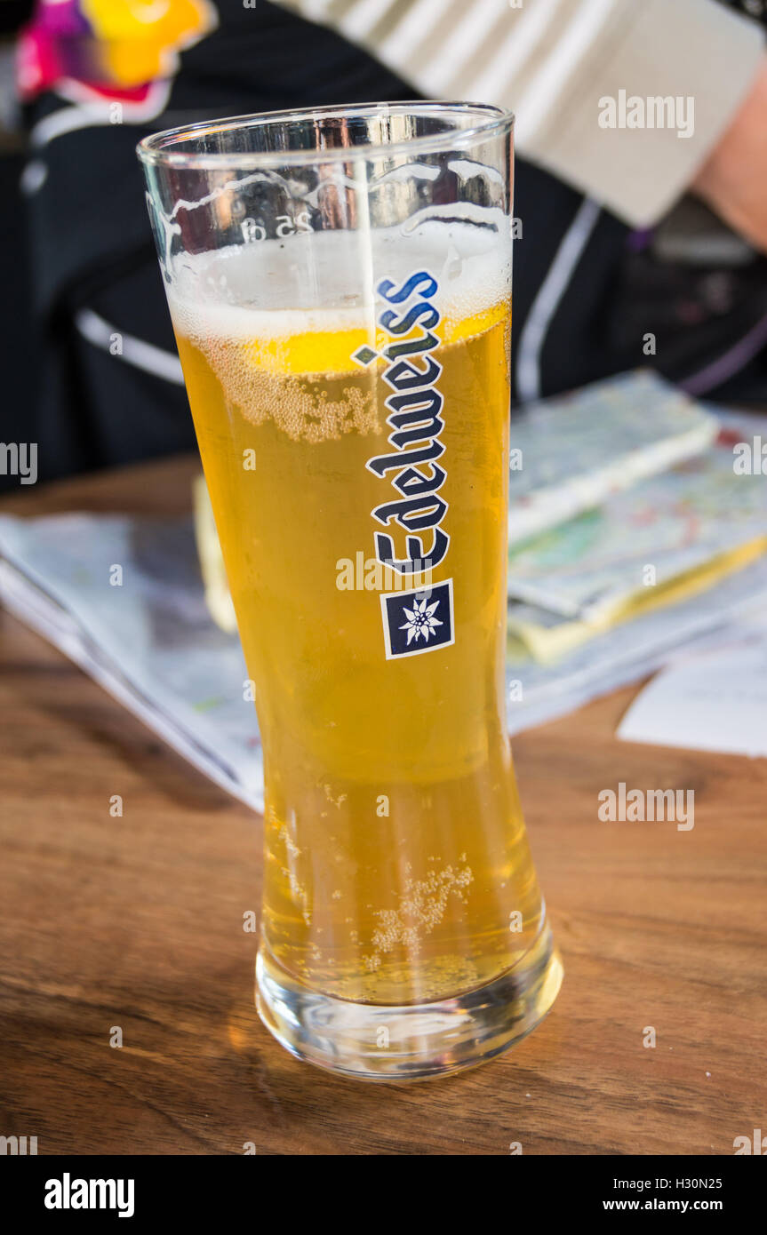 A glass of Edelweiss Austrian wheat beer on a bar with a tourist map, Nancy, Meurthe-et-Moselle, France Stock Photo