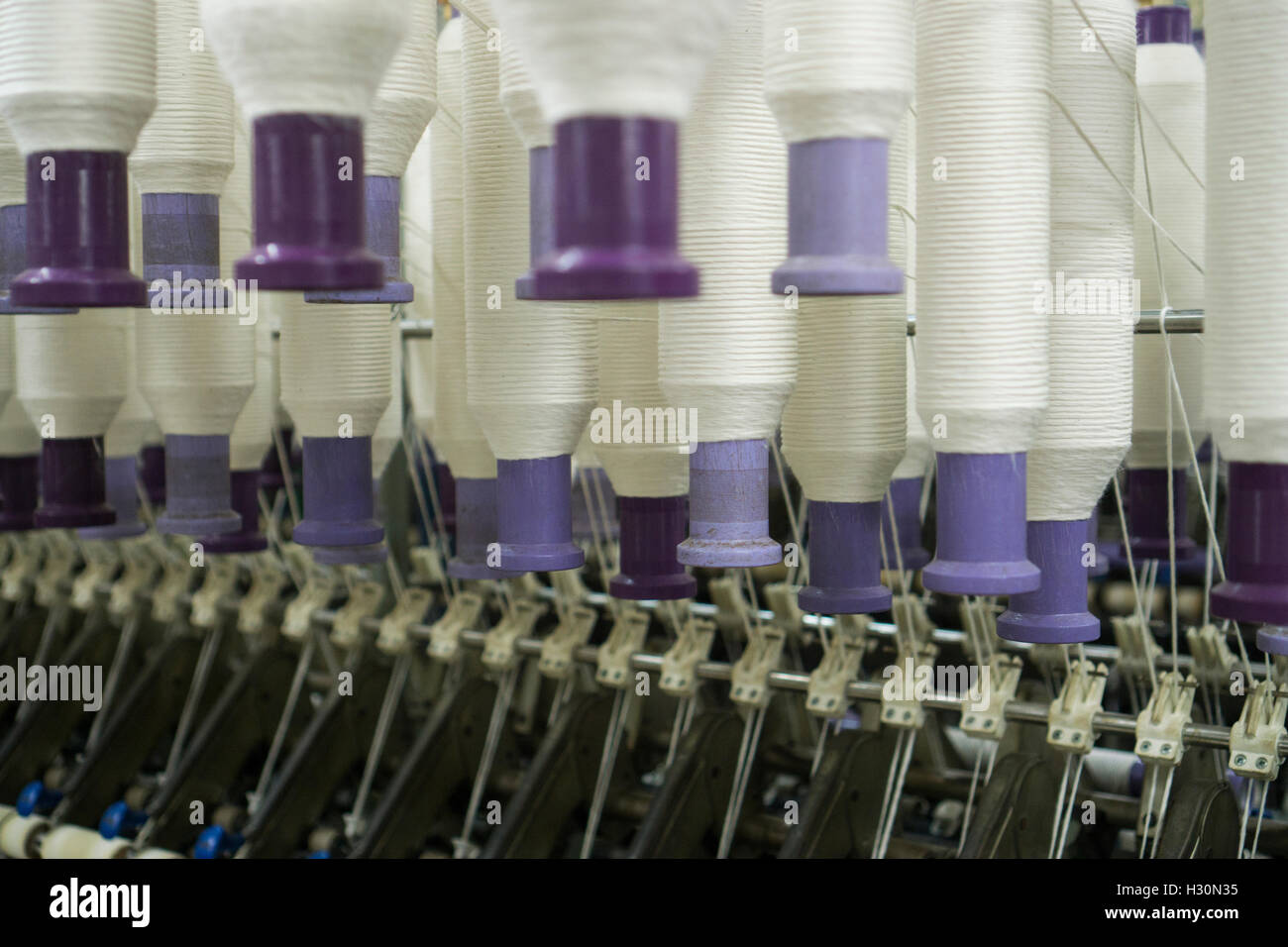 Cotton spools inside cotton mill Multan Pakistan Stock Photo