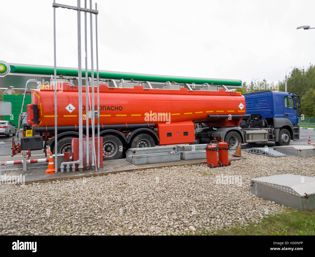 Truck unload petrol on filling station BP at day time Stock Photo