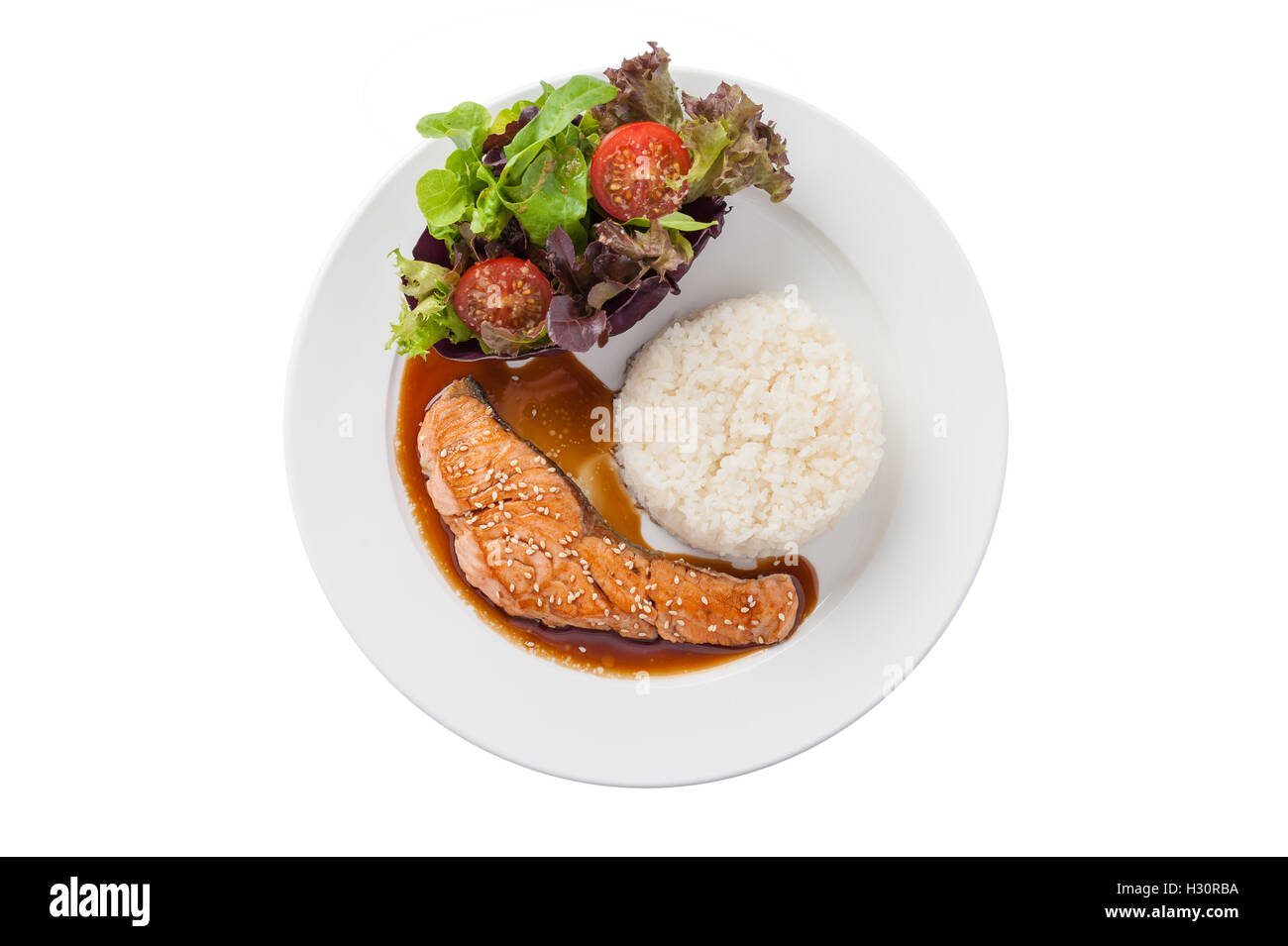 Top view of Fusion food style grilled salmon dressed with Japanese sweet sauce (Teriyaki) including Thai rice garnished with veg Stock Photo